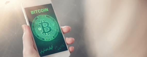 Coinstar green colored bitcoin name and logo displayed on a phone held in a hand