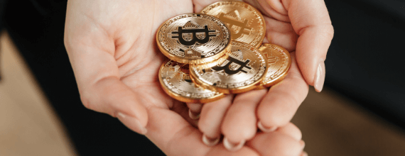 Bitcoin tokens held in cupped hands reverently